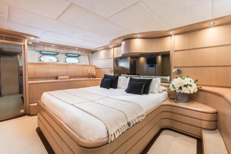 a room with a bed and a chair aboard B4 Yacht for Charter