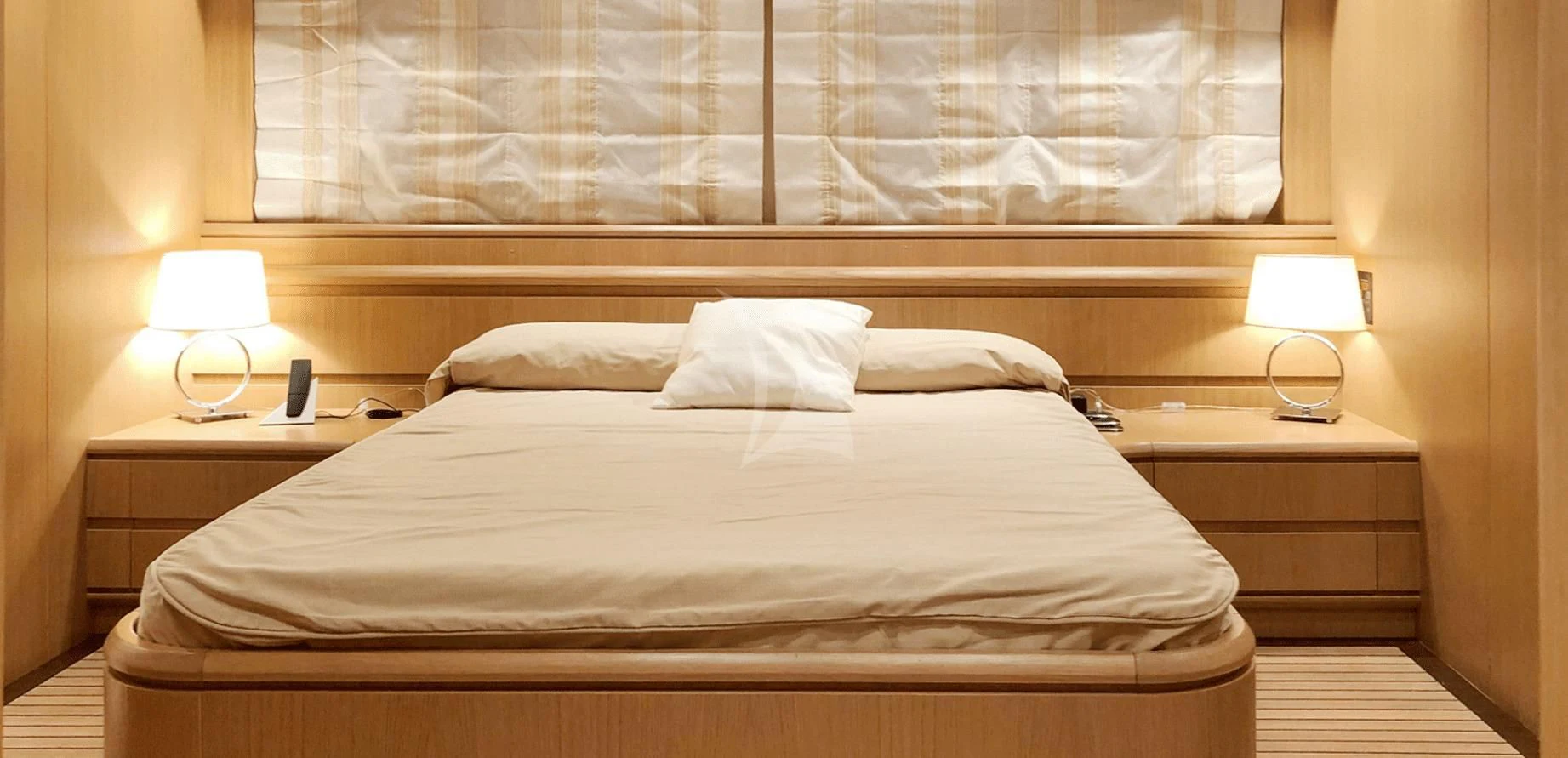 a bed with a white pillow aboard B4 Yacht for Charter