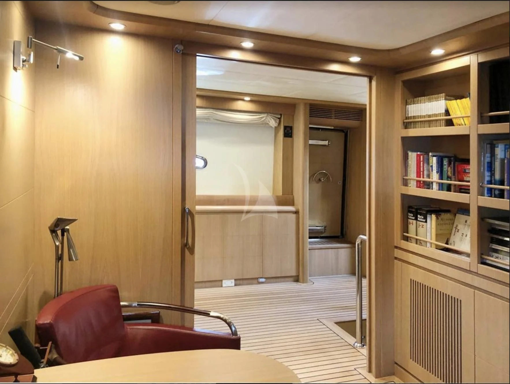 a room with a bookcase and a couch aboard B4 Yacht for Charter