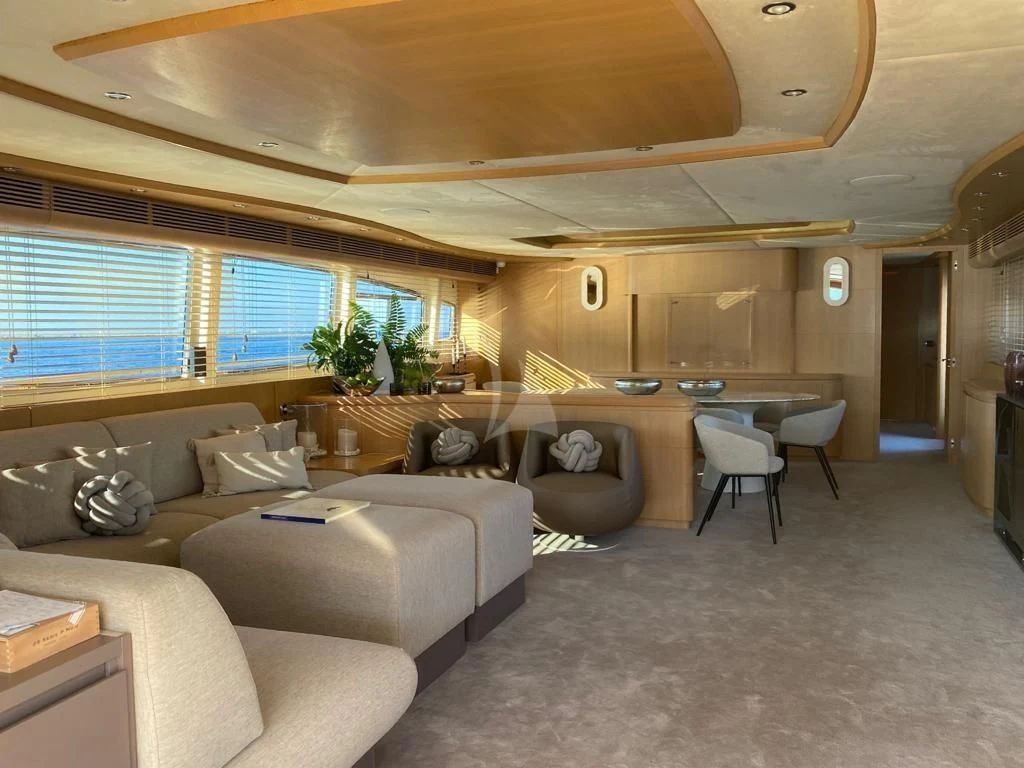 a living room with a couch and a table aboard B4 Yacht for Charter