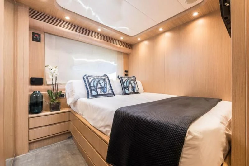 a bed with white sheets aboard B4 Yacht for Charter
