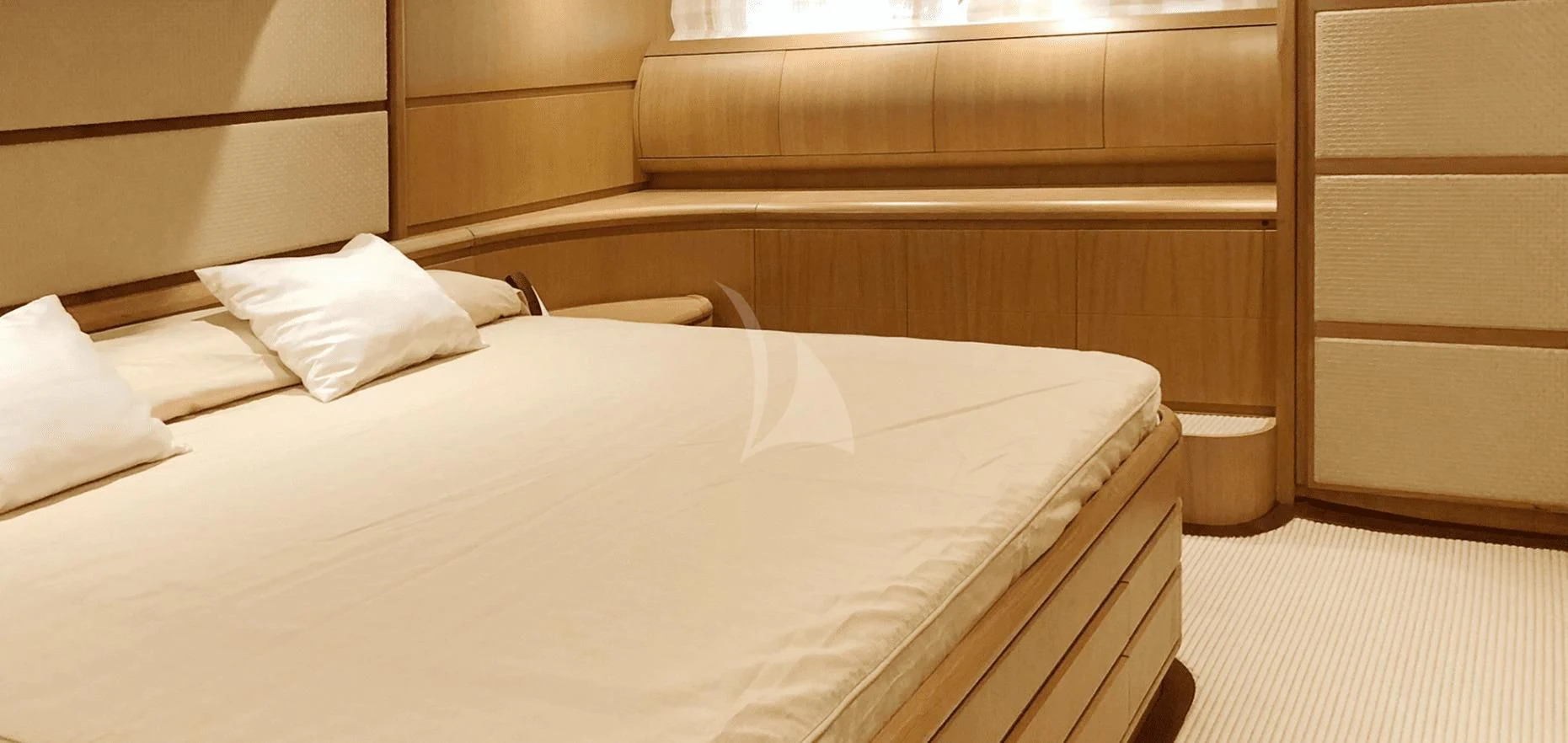 a bed with white sheets aboard B4 Yacht for Charter
