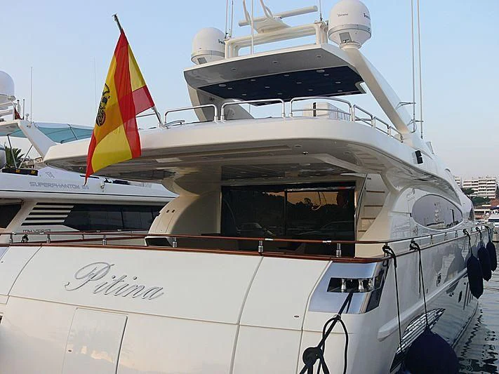 a boat with a flag on the front aboard B4 Yacht for Charter