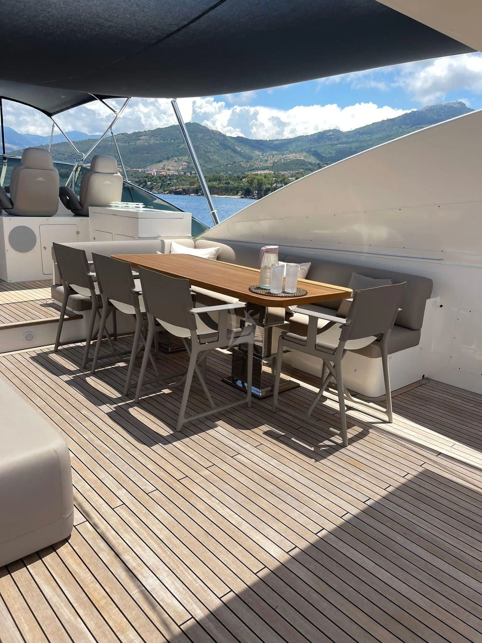 a deck with a table and chairs aboard B4 Yacht for Charter