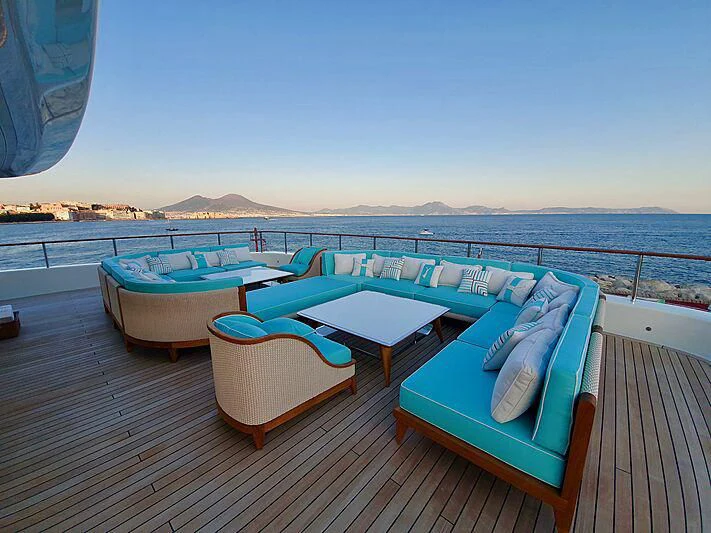 a deck with a pool and chairs on it aboard MIMTEE Yacht for Sale
