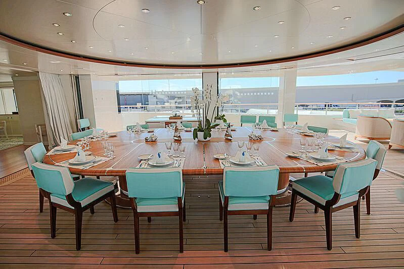 a room with tables and chairs aboard MIMTEE Yacht for Sale