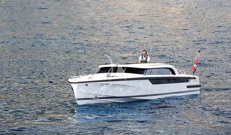 a person driving a white boat on the water aboard MIMTEE Yacht for Sale