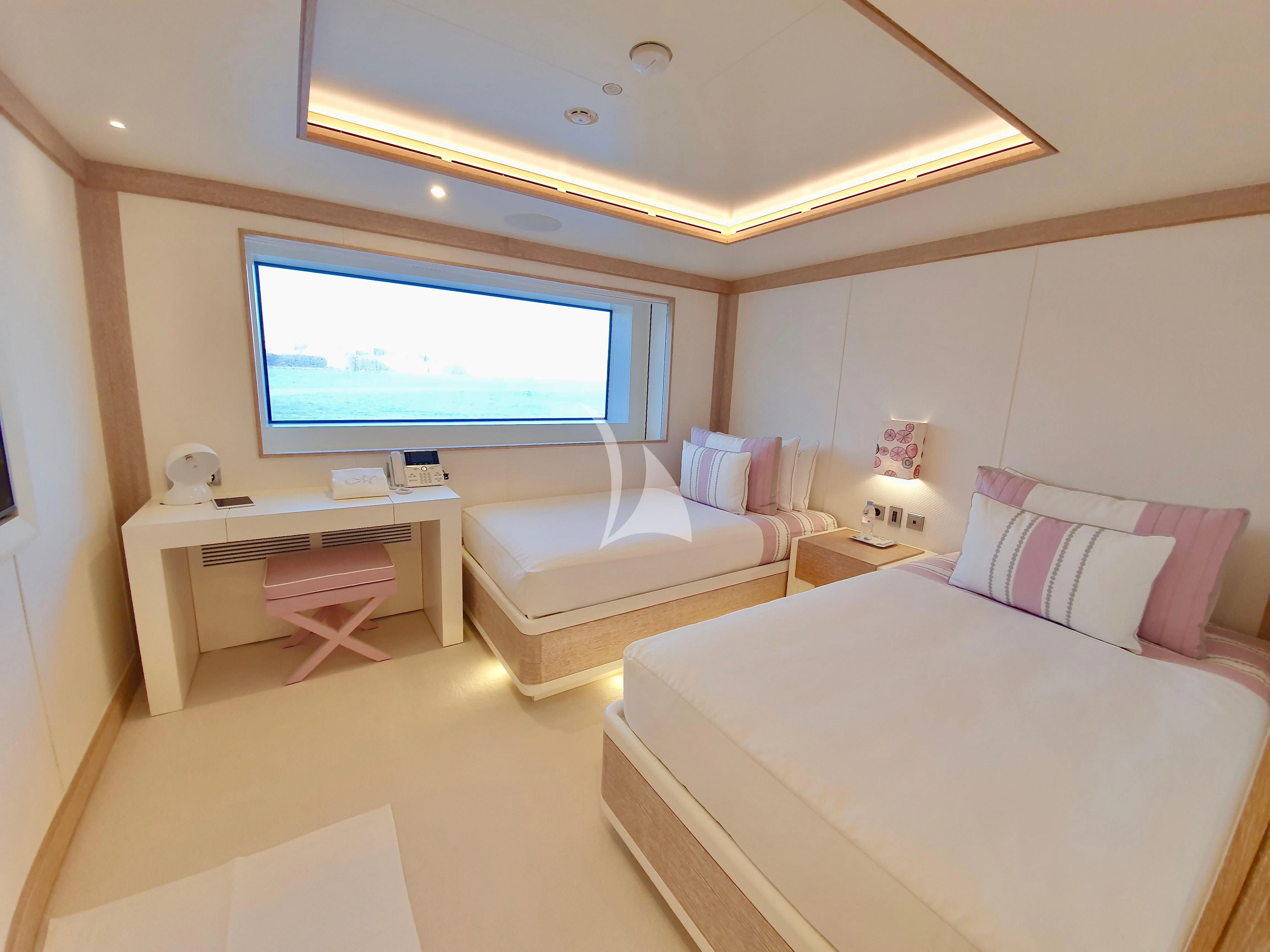 a room with a bed and a tv on the wall aboard MIMTEE Yacht for Sale
