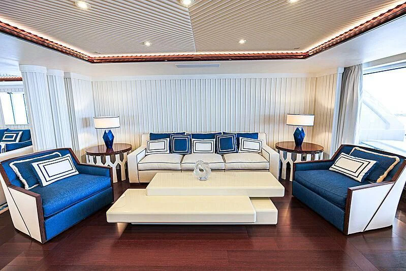 a living room with a couch and a table aboard MIMTEE Yacht for Sale