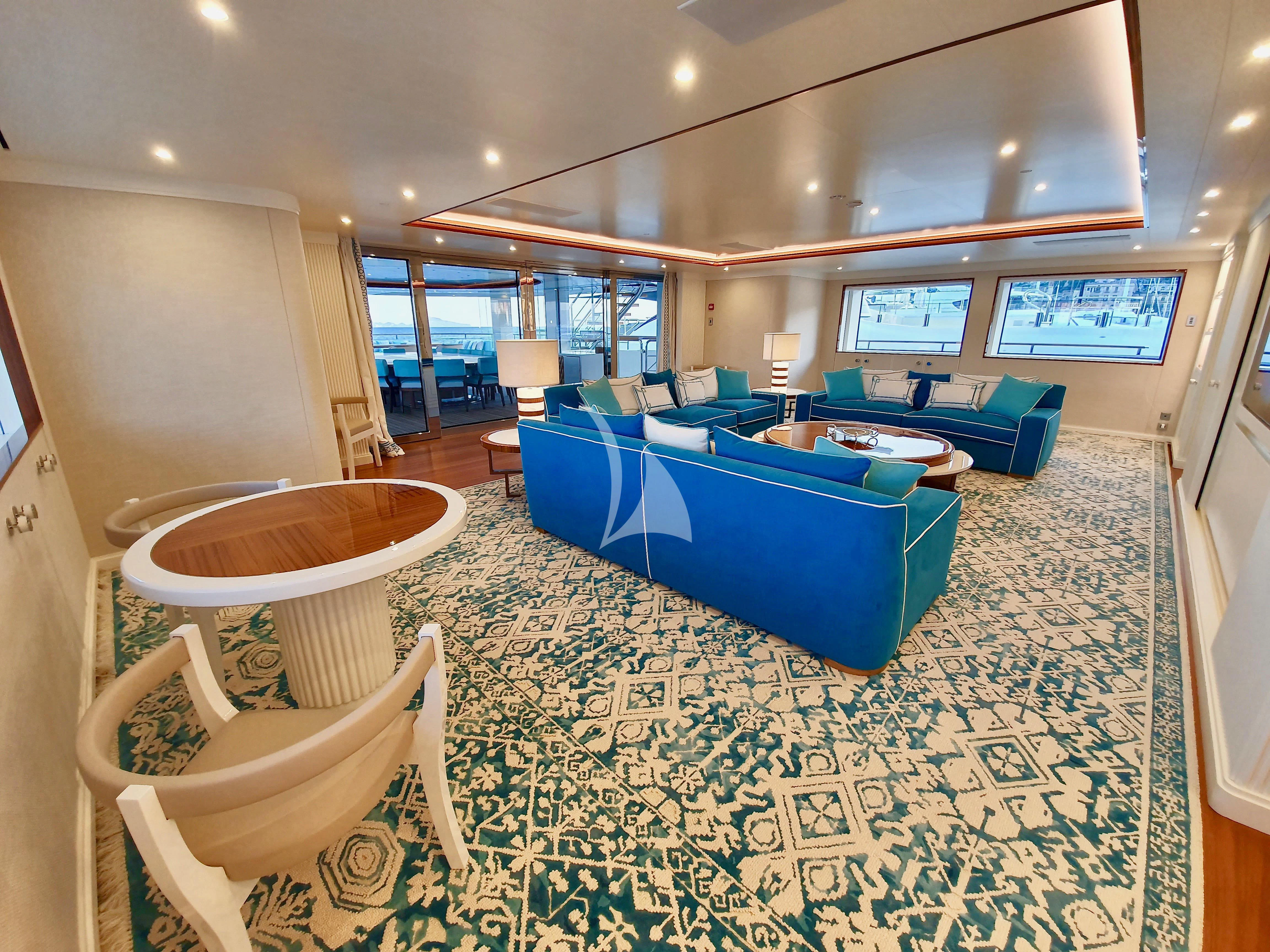 a pool table and chairs in a room with a pool table and chairs aboard MIMTEE Yacht for Sale