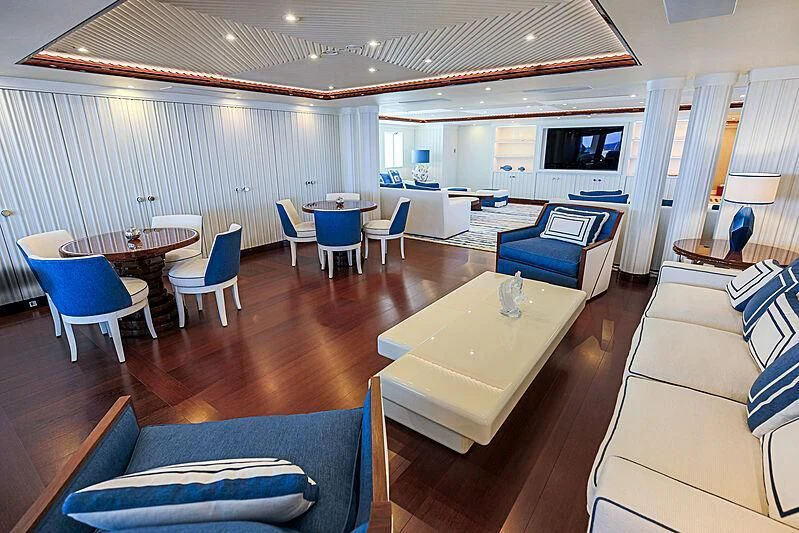 a room with a table chairs and a couch aboard MIMTEE Yacht for Sale