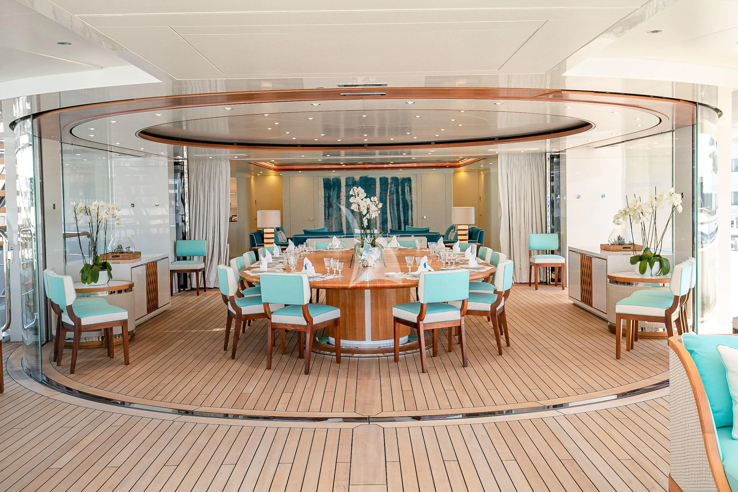 a room with tables and chairs aboard MIMTEE Yacht for Sale