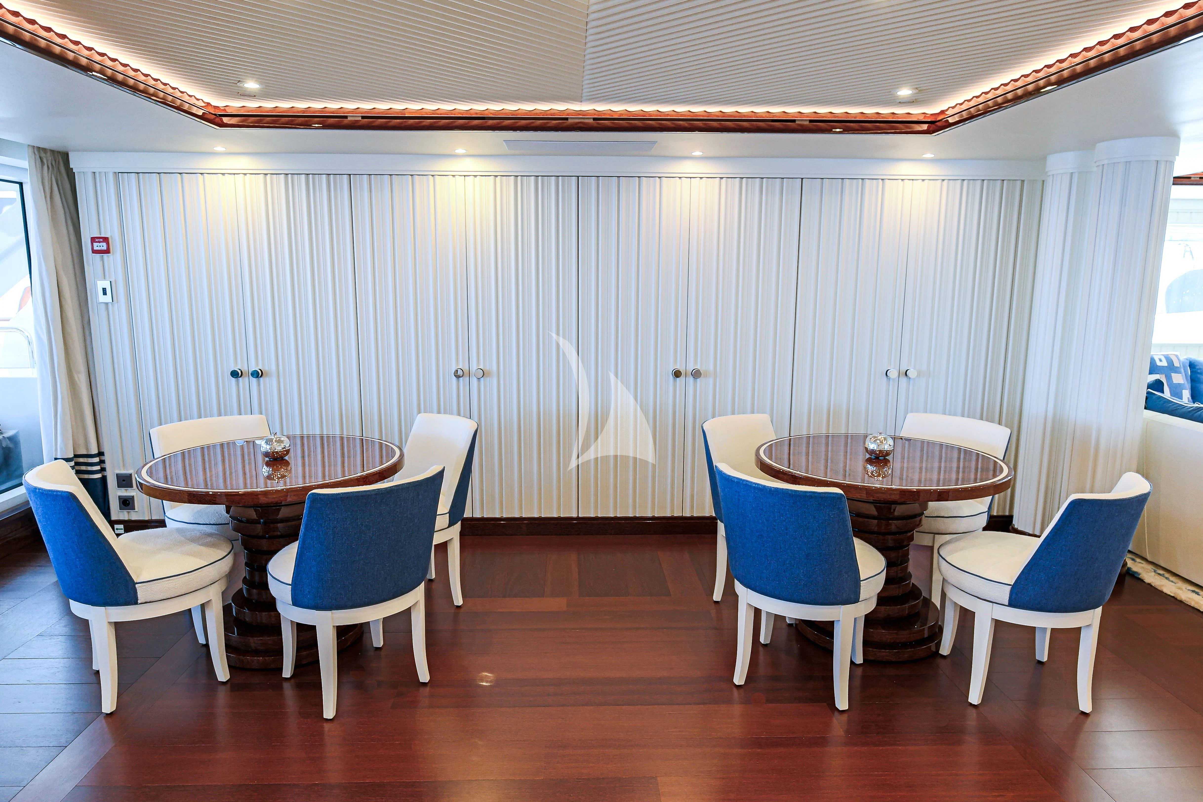 a room with a table and chairs aboard MIMTEE Yacht for Sale