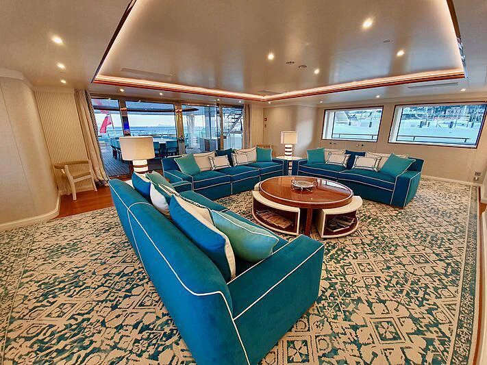 a living room with a couch and a table aboard MIMTEE Yacht for Sale