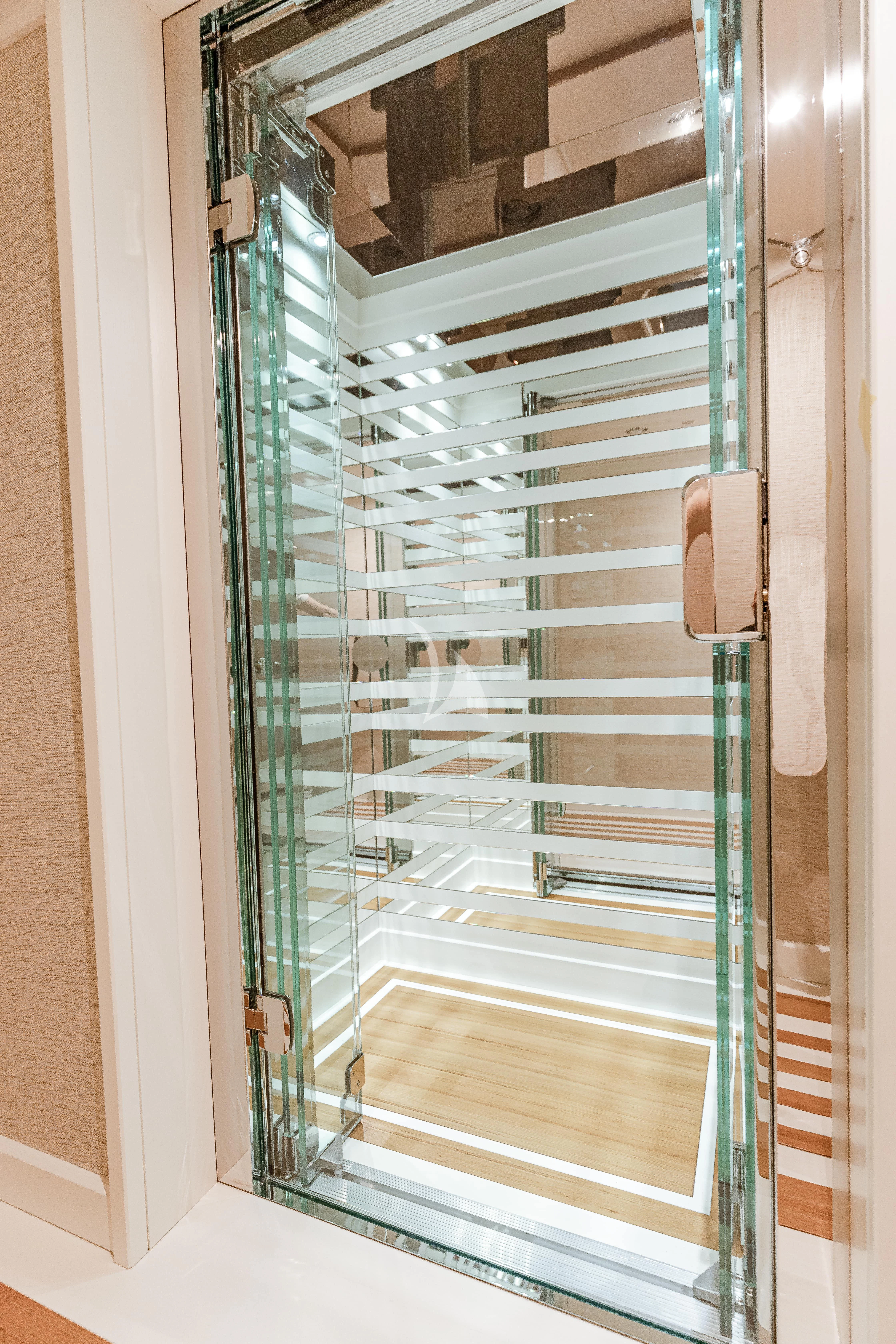 a large room with glass walls aboard MIMTEE Yacht for Sale