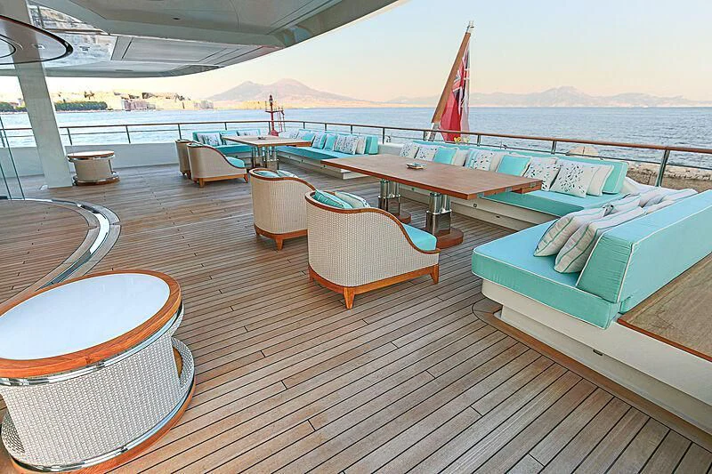a deck with a deck and chairs on it aboard MIMTEE Yacht for Sale