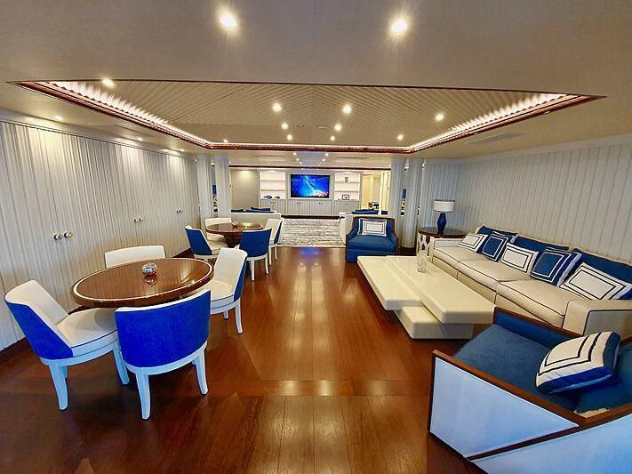 a room with tables and chairs aboard MIMTEE Yacht for Sale