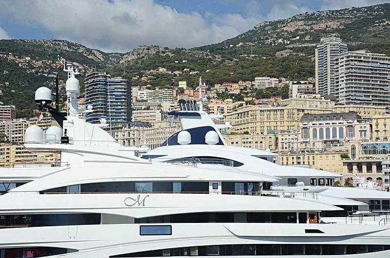a large white yacht in a harbor aboard MIMTEE Yacht for Sale