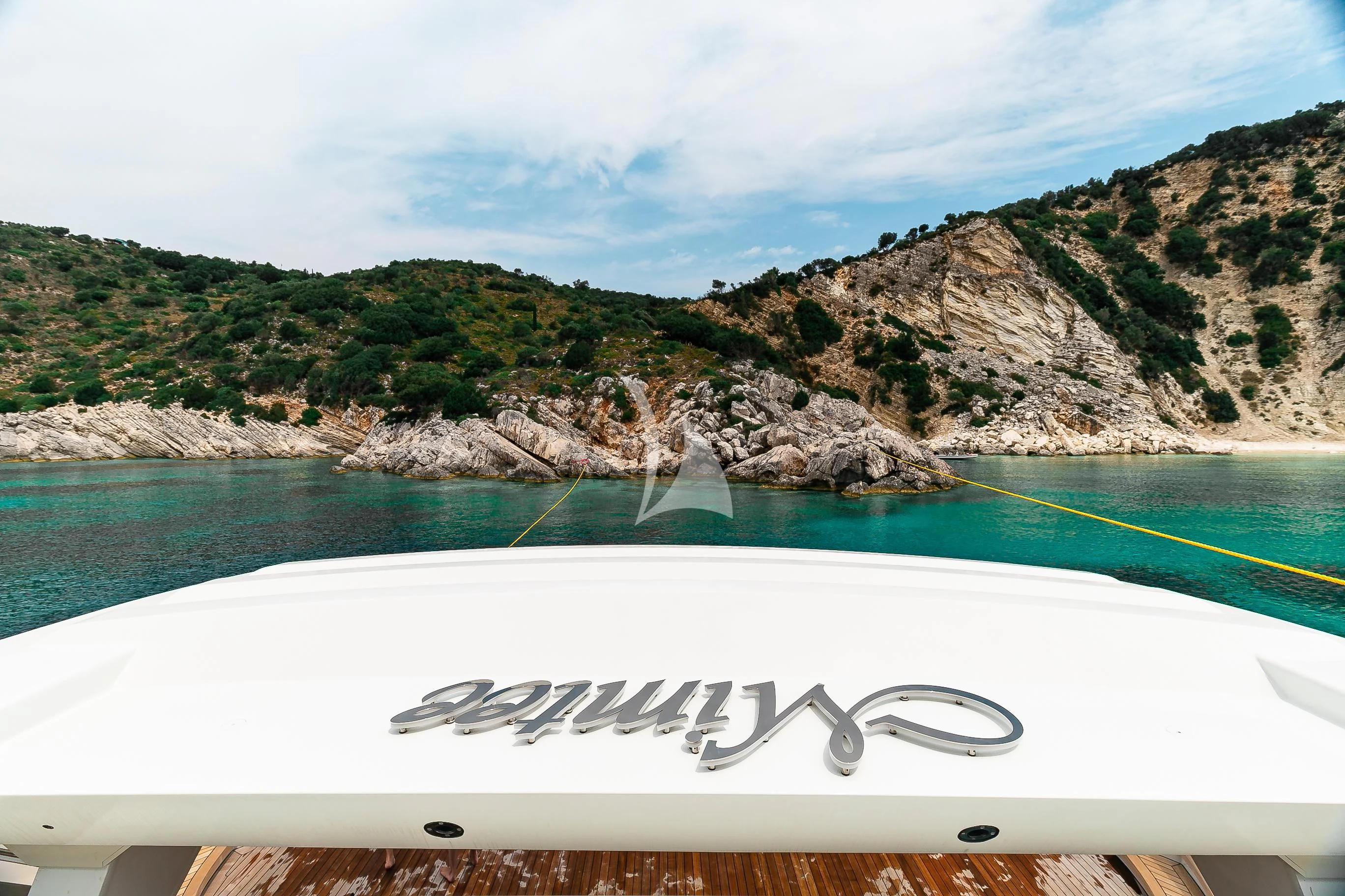 a white surfboard on a beach aboard MIMTEE Yacht for Sale