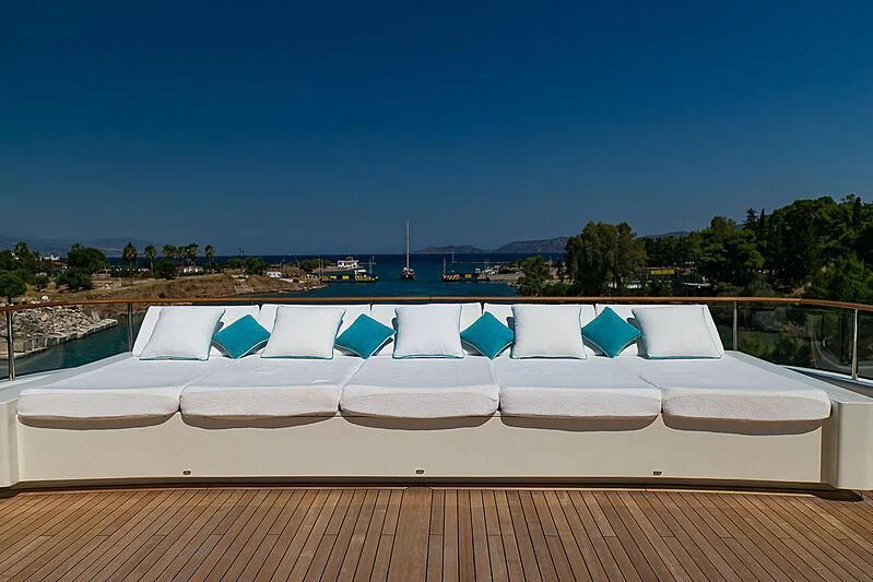 a roof with a building and a body of water in the background aboard MIMTEE Yacht for Sale