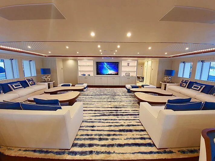 a large room with couches and a tv aboard MIMTEE Yacht for Sale