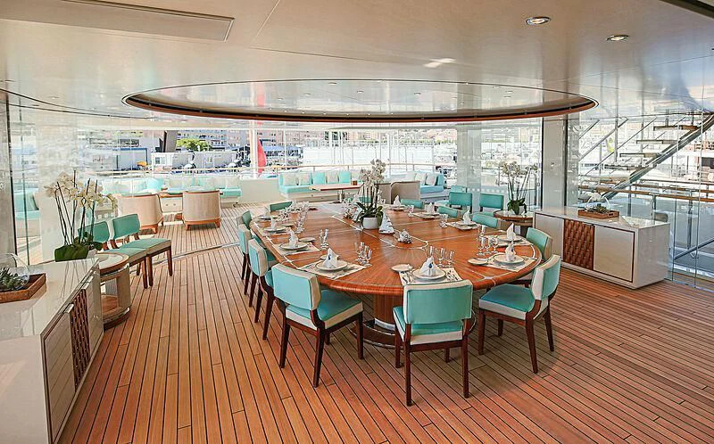 a large room with tables and chairs aboard MIMTEE Yacht for Sale