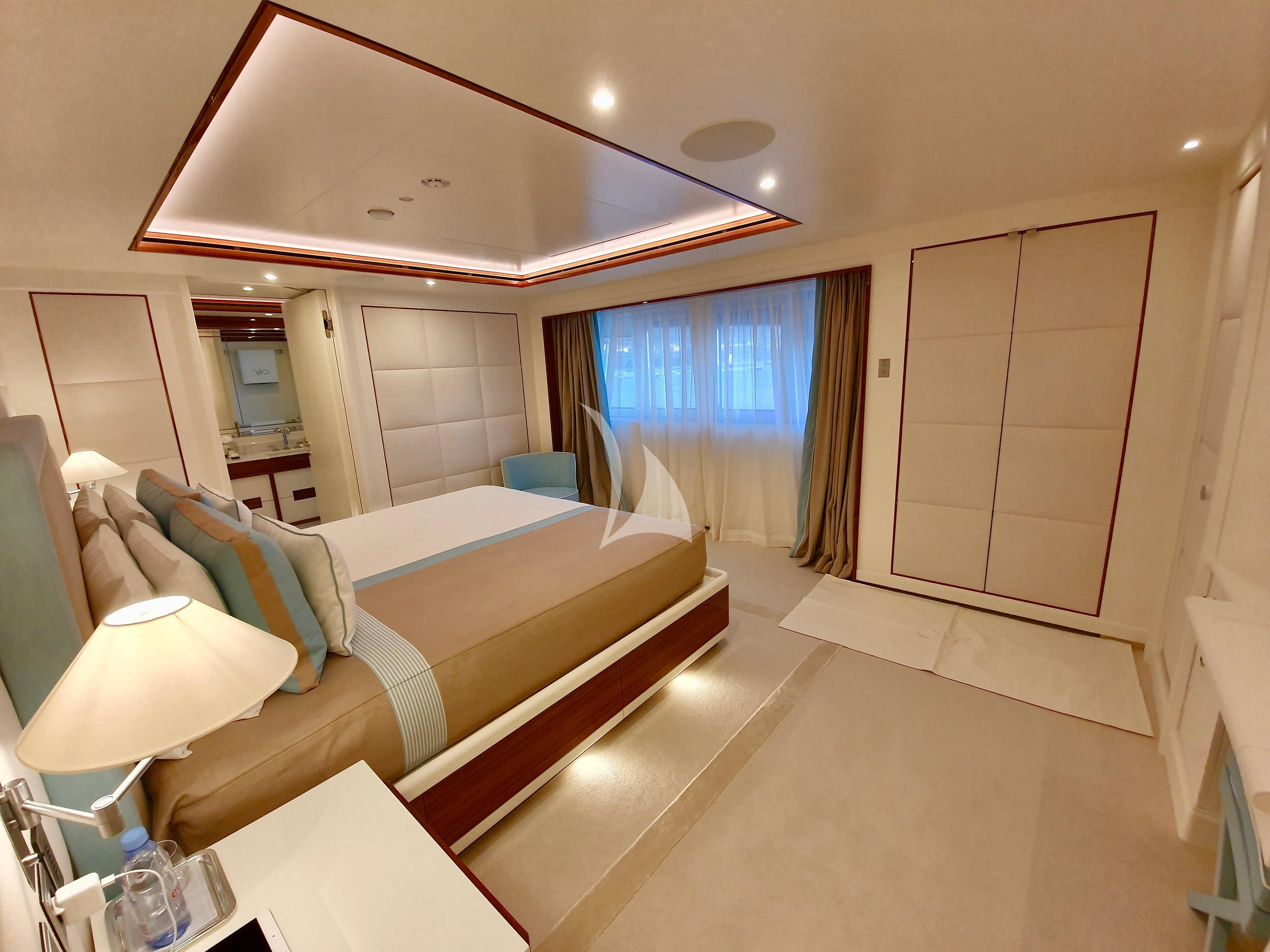 a room with a bed and a couch aboard MIMTEE Yacht for Sale