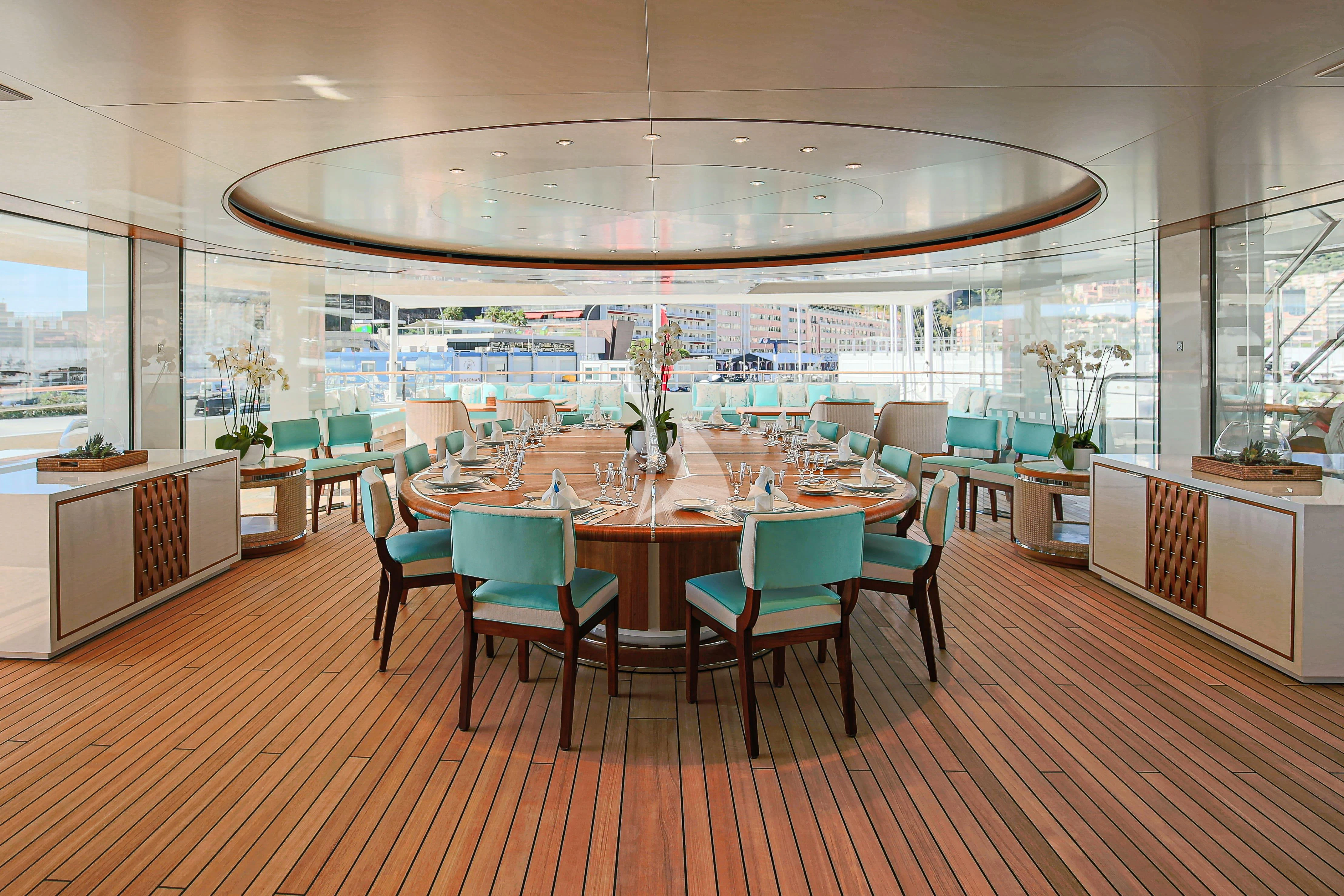 a room with tables and chairs aboard MIMTEE Yacht for Sale