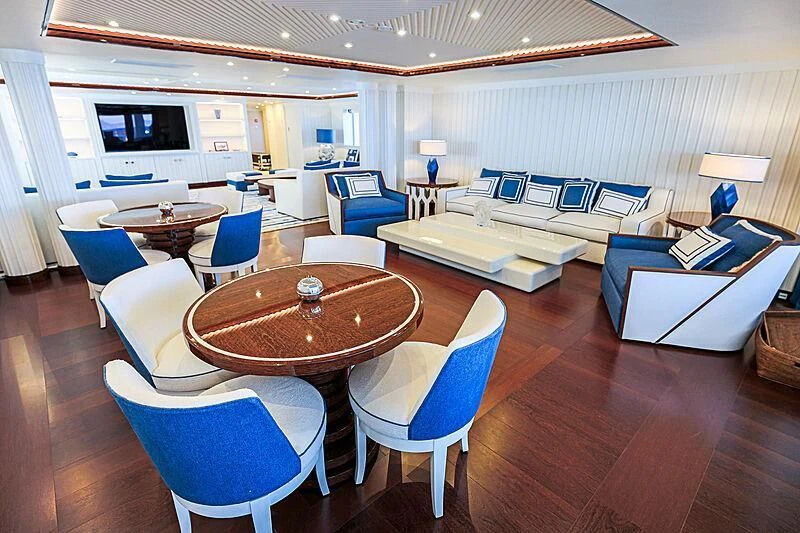 a living room with a table and chairs aboard MIMTEE Yacht for Sale