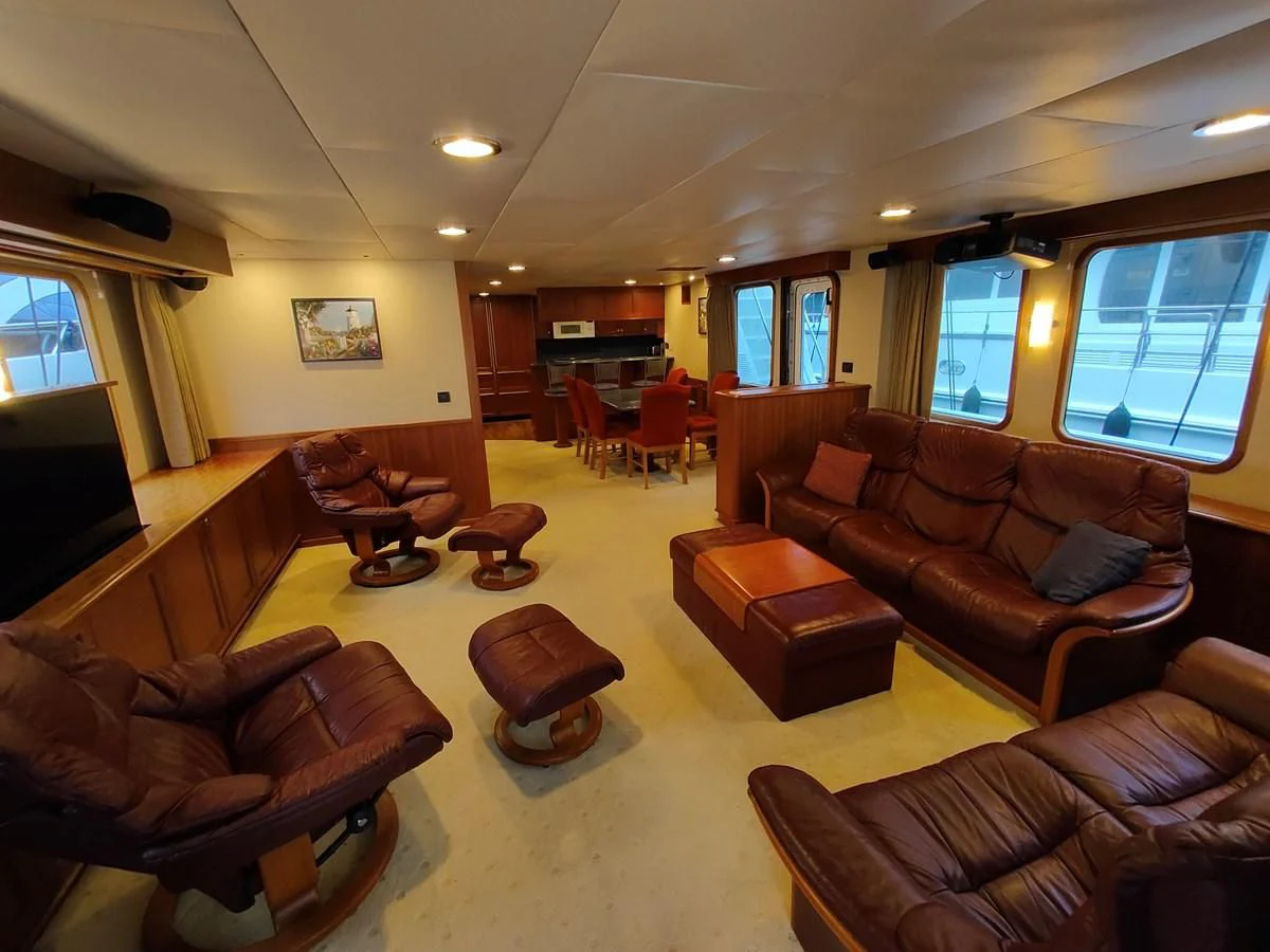 a living room with leather couches aboard SPELLBOUND Yacht for Sale