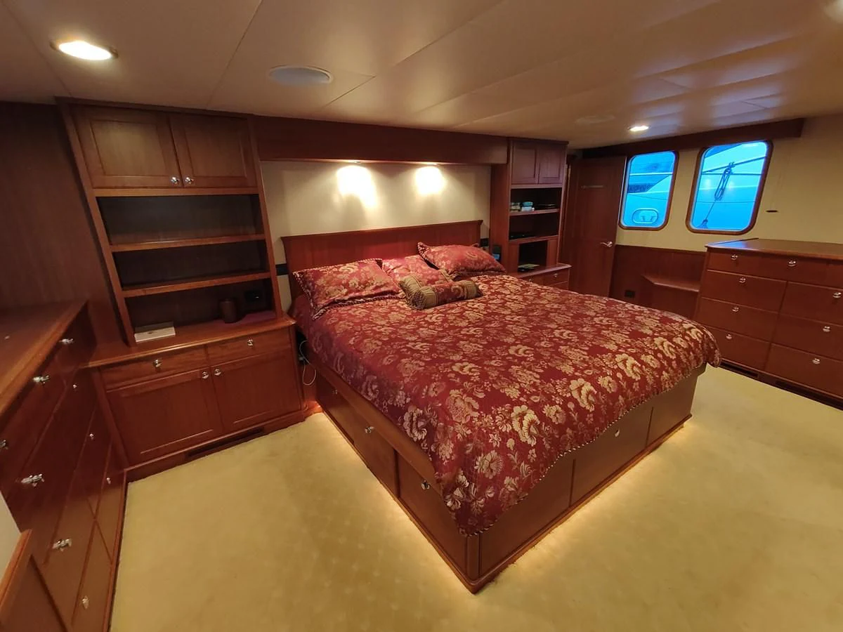 a bedroom with a large bed aboard SPELLBOUND Yacht for Sale