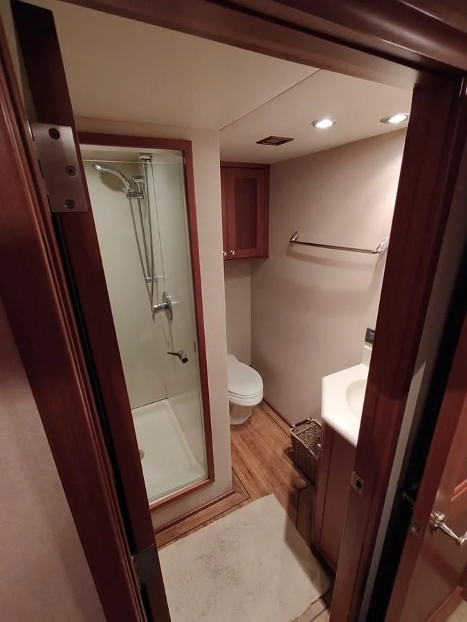 a bathroom with a shower and toilet aboard SPELLBOUND Yacht for Sale