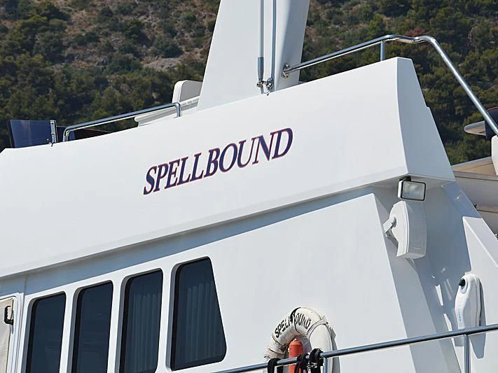 a white building with a sign on it aboard SPELLBOUND Yacht for Sale