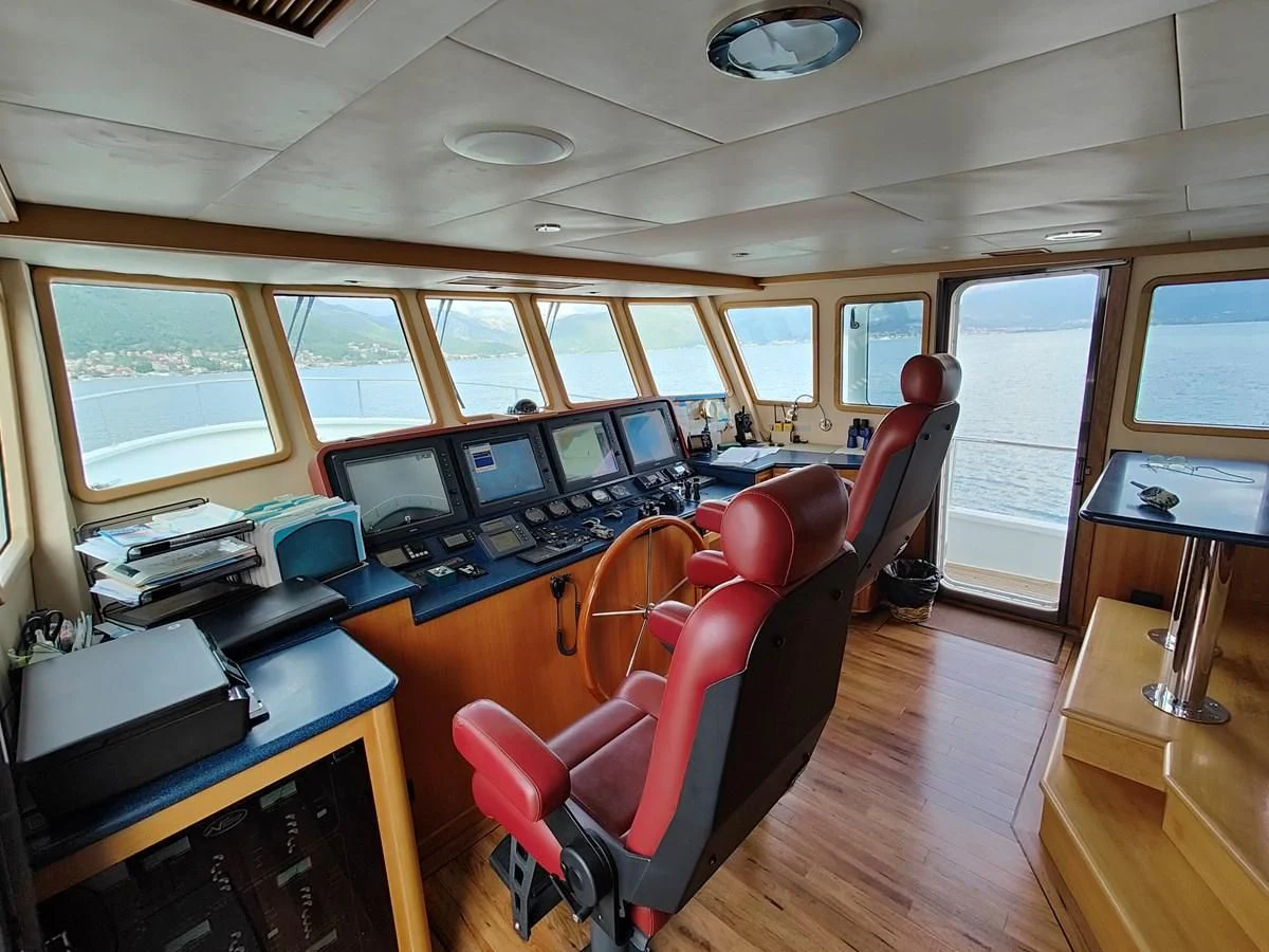 a room with a desk and chairs aboard SPELLBOUND Yacht for Sale
