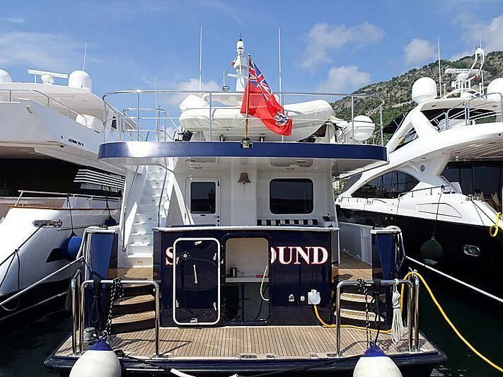 a boat with a flag on the deck aboard SPELLBOUND Yacht for Sale