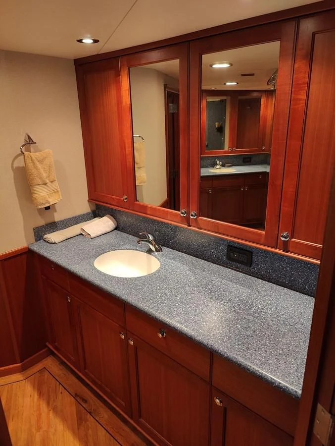a bathroom with a large mirror aboard SPELLBOUND Yacht for Sale