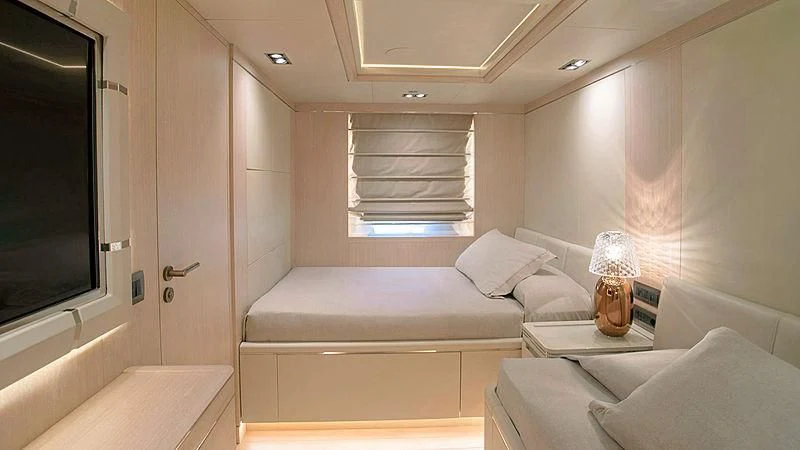 a room with a bed and a window aboard JAZ Yacht for Charter