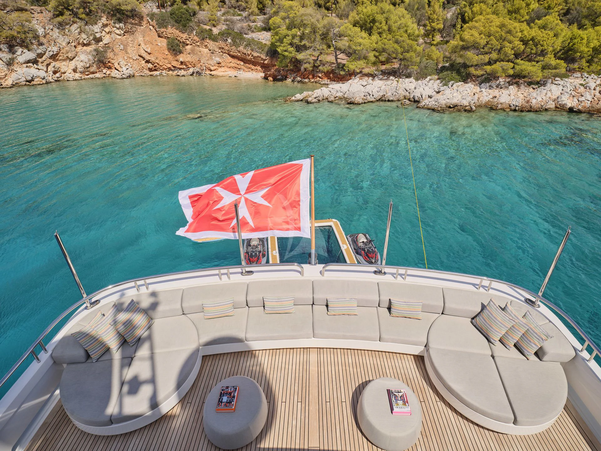 a boat with a flag on it aboard JAZ Yacht for Charter