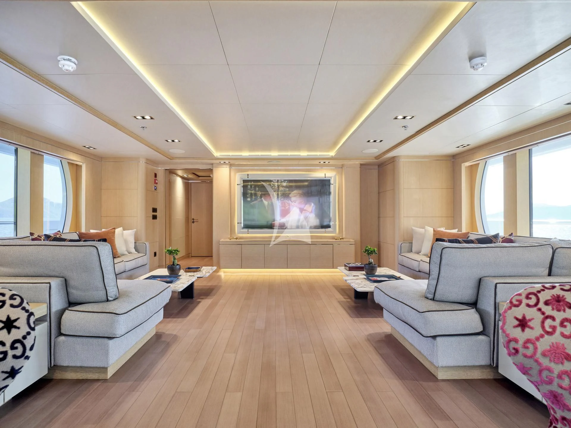 a living room with a wood floor aboard JAZ Yacht for Charter