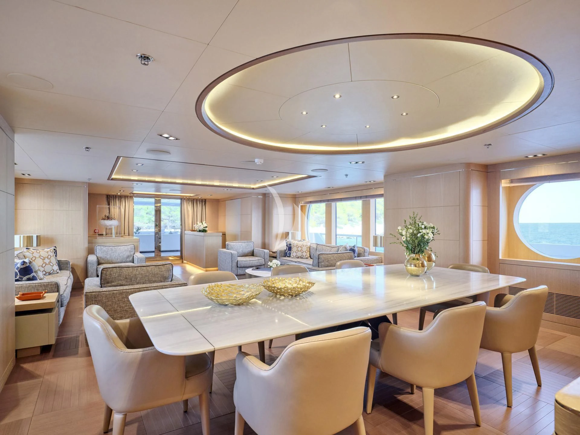 a large dining room with a large chandelier aboard JAZ Yacht for Charter