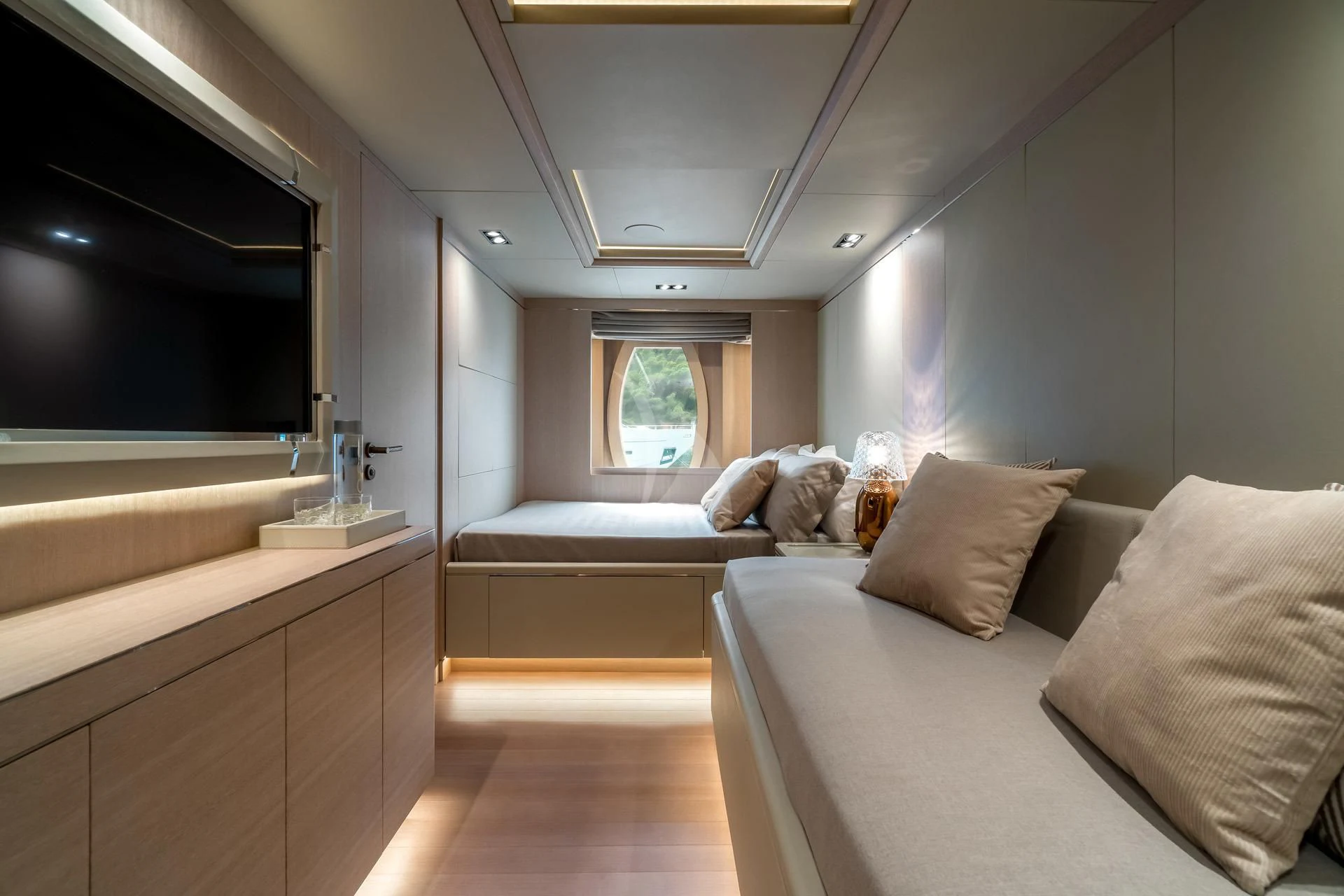 a room with a bed and a window aboard JAZ Yacht for Charter