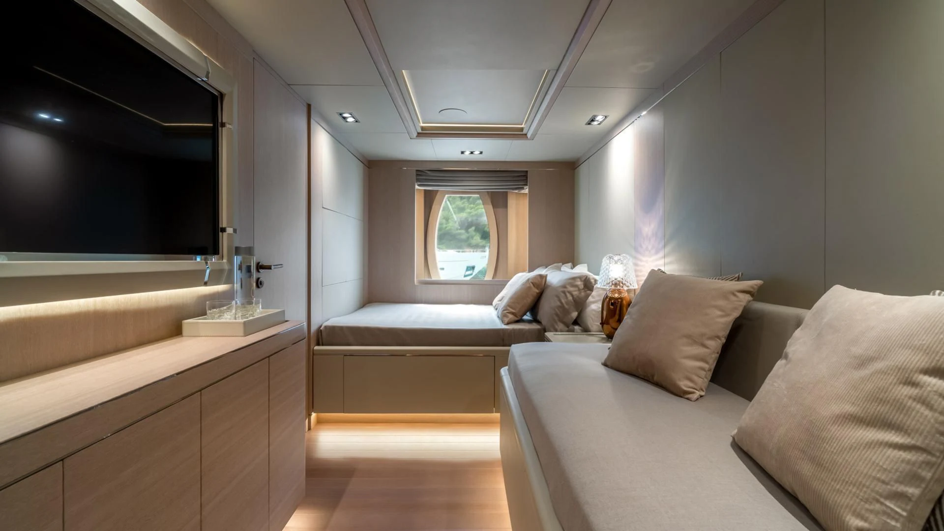 a room with a bed and a window aboard JAZ Yacht for Charter