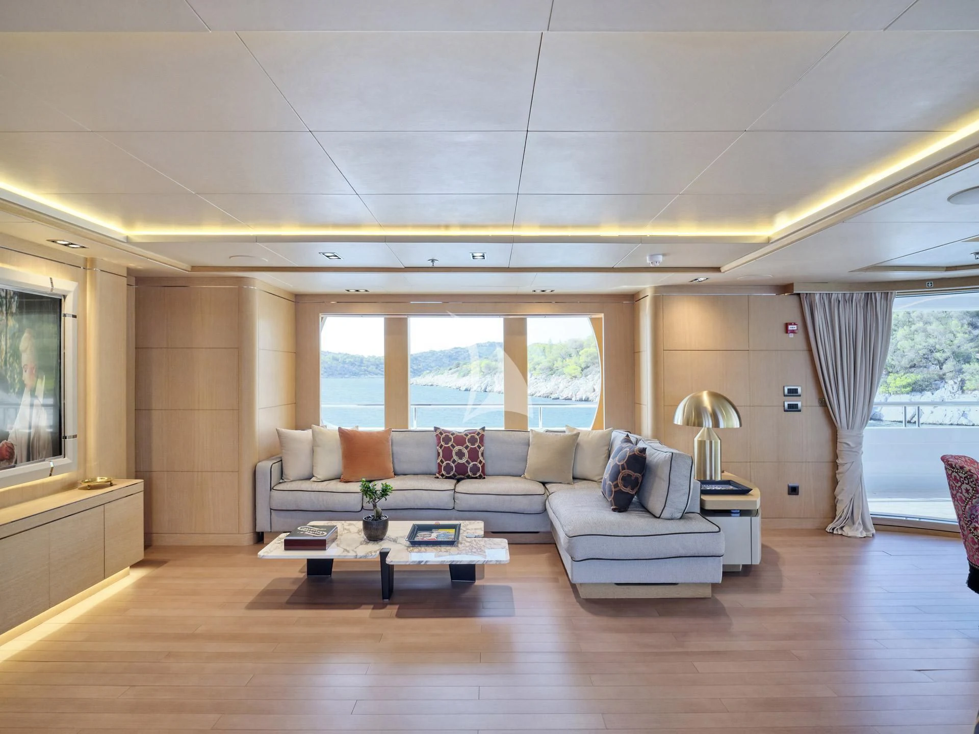 a living room with a large window aboard JAZ Yacht for Charter