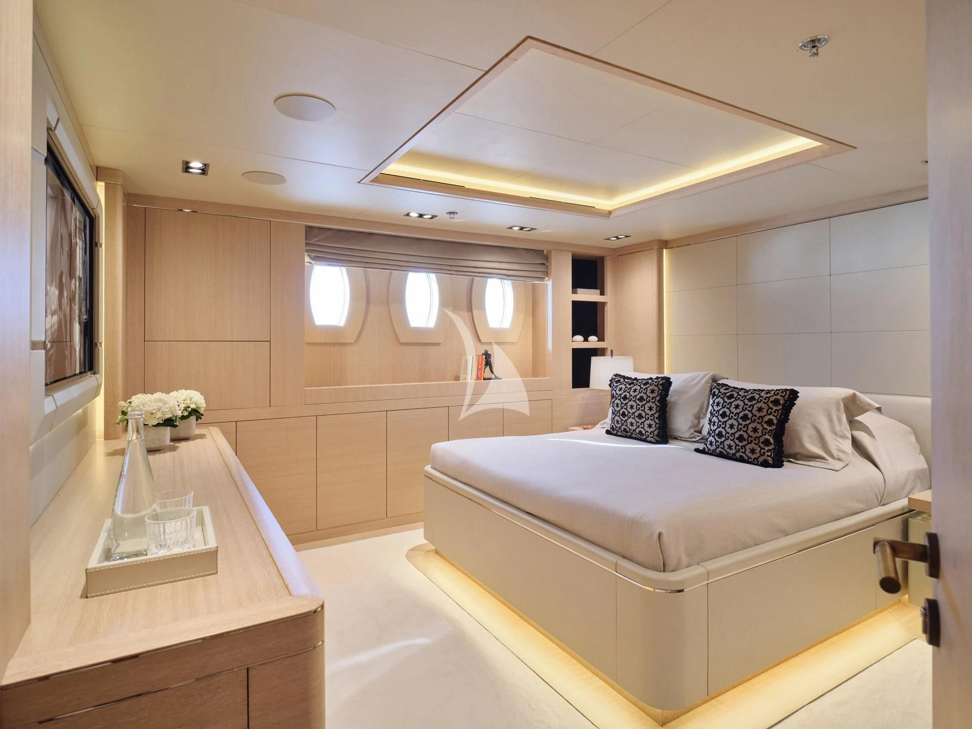 a room with a bed and a table aboard JAZ Yacht for Charter