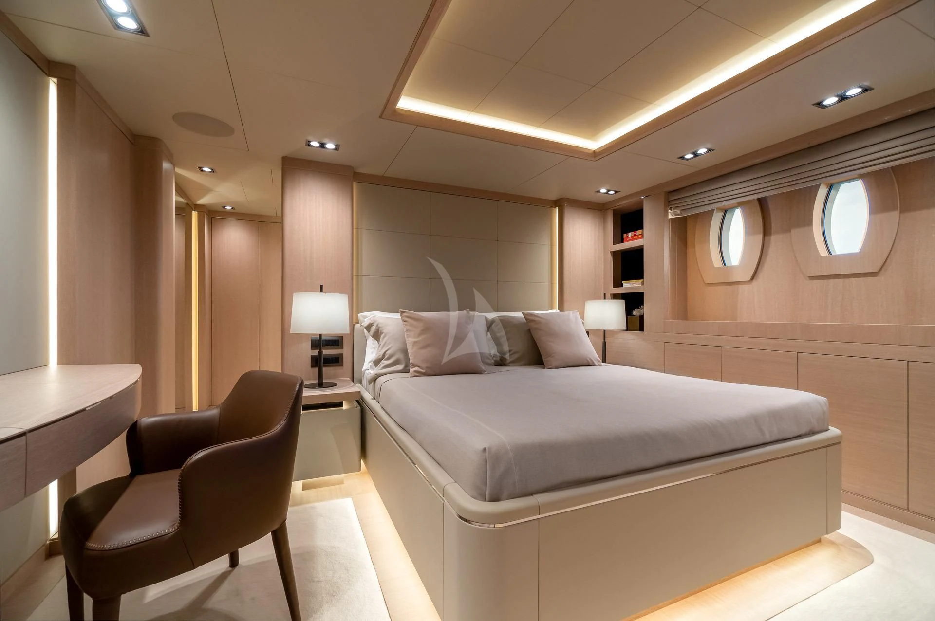 a room with a bed and a chair aboard JAZ Yacht for Charter