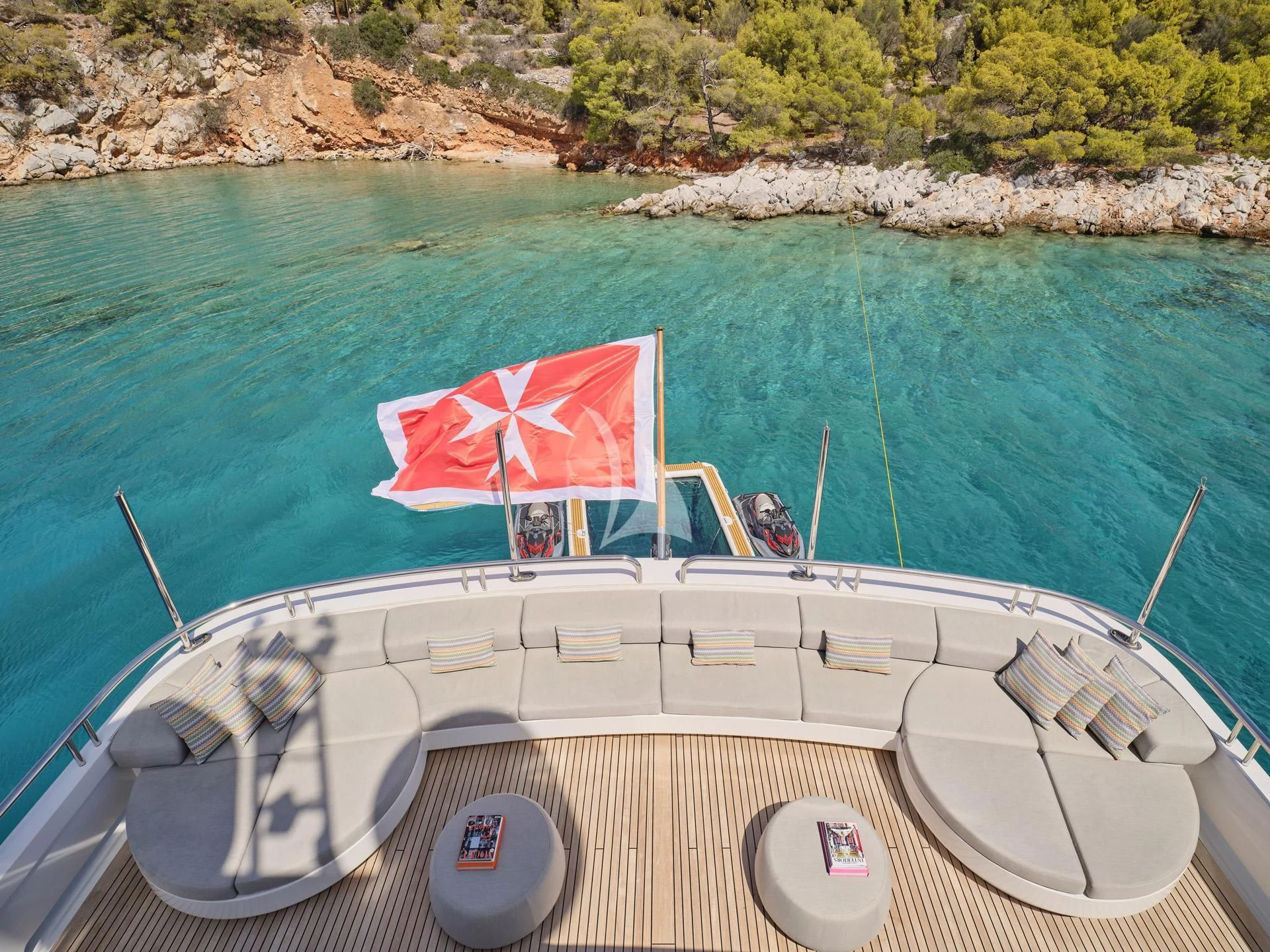 a boat with a flag on it aboard JAZ Yacht for Charter