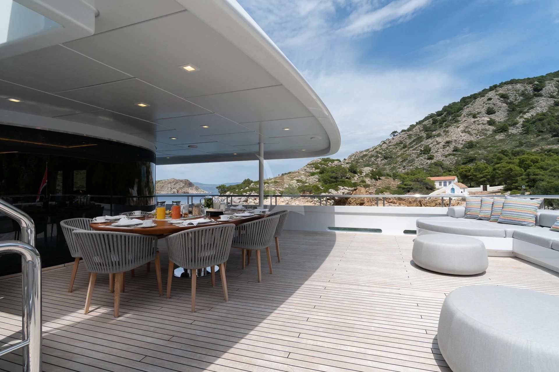 a deck with tables and chairs aboard JAZ Yacht for Charter