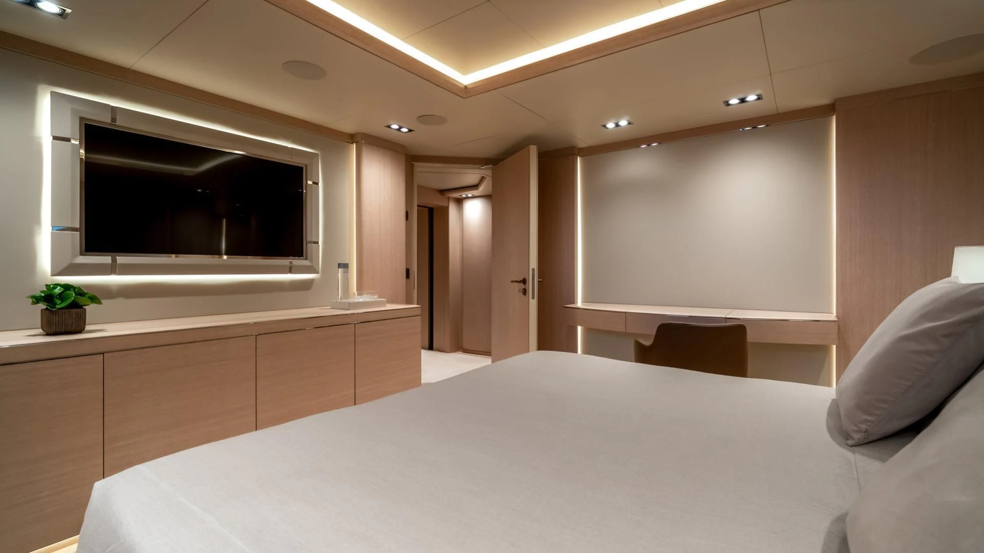 a room with a bed and a television aboard JAZ Yacht for Charter