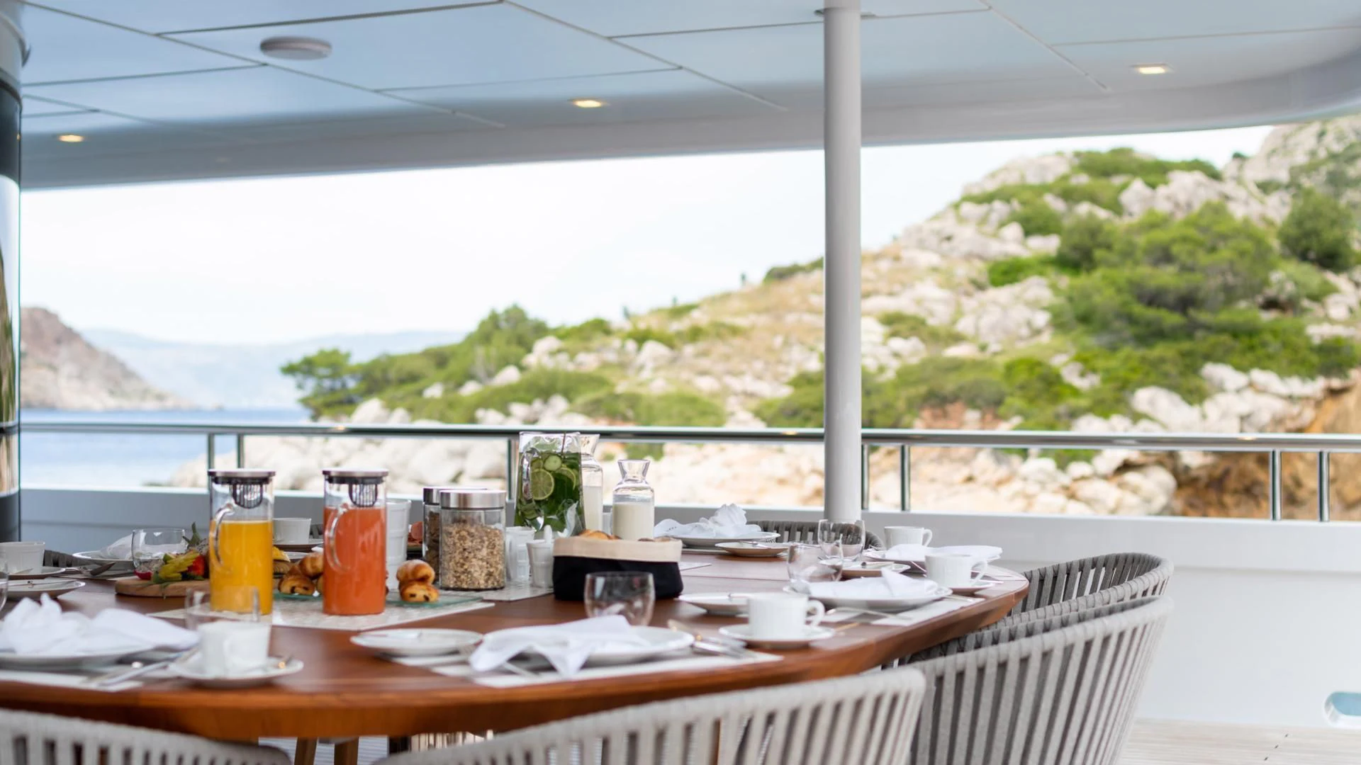 a table with food and drinks on it aboard JAZ Yacht for Charter