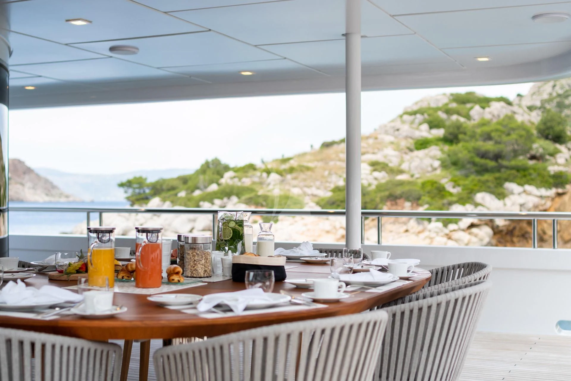 a table with food and drinks on it aboard JAZ Yacht for Charter
